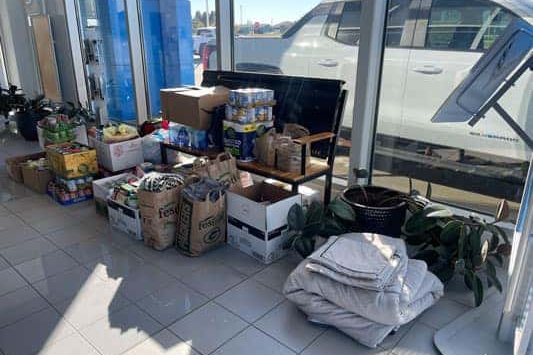 Donated food, water and supplies collected inside a Wheelers dealership